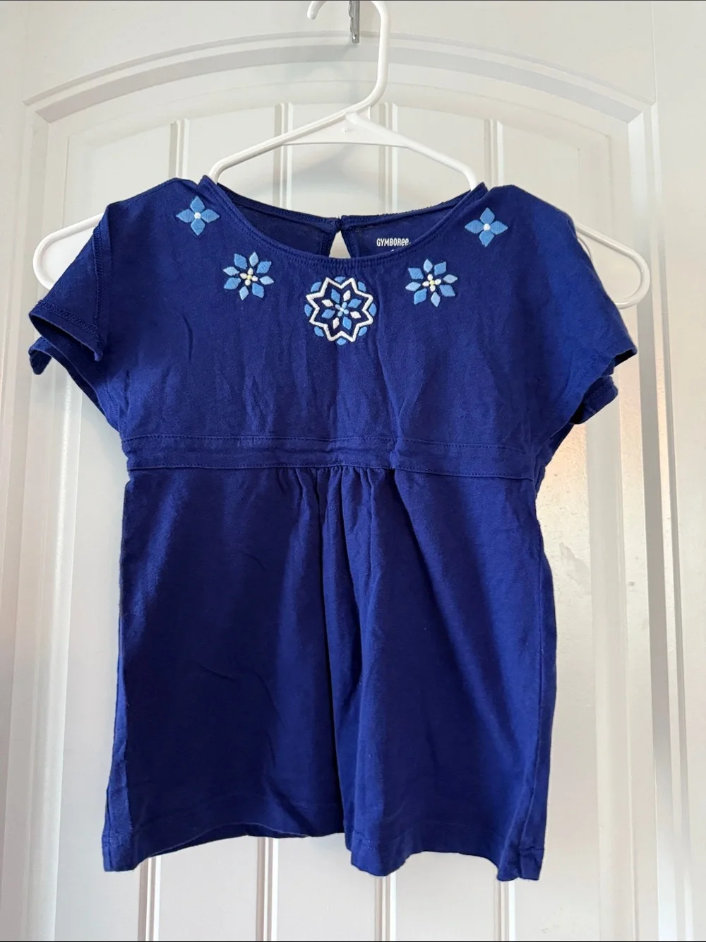 Gently worn Royal Blue Short Sleeve Top with Light Blue Floral Embroidery